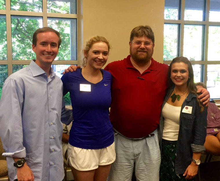 This is a photo of Rod Bridges, Mary Kate Berger, Eric Thomas Weber, and Natalie King at the UM 2016 Student Alumni Council 'Random Acts of Kindness' event.