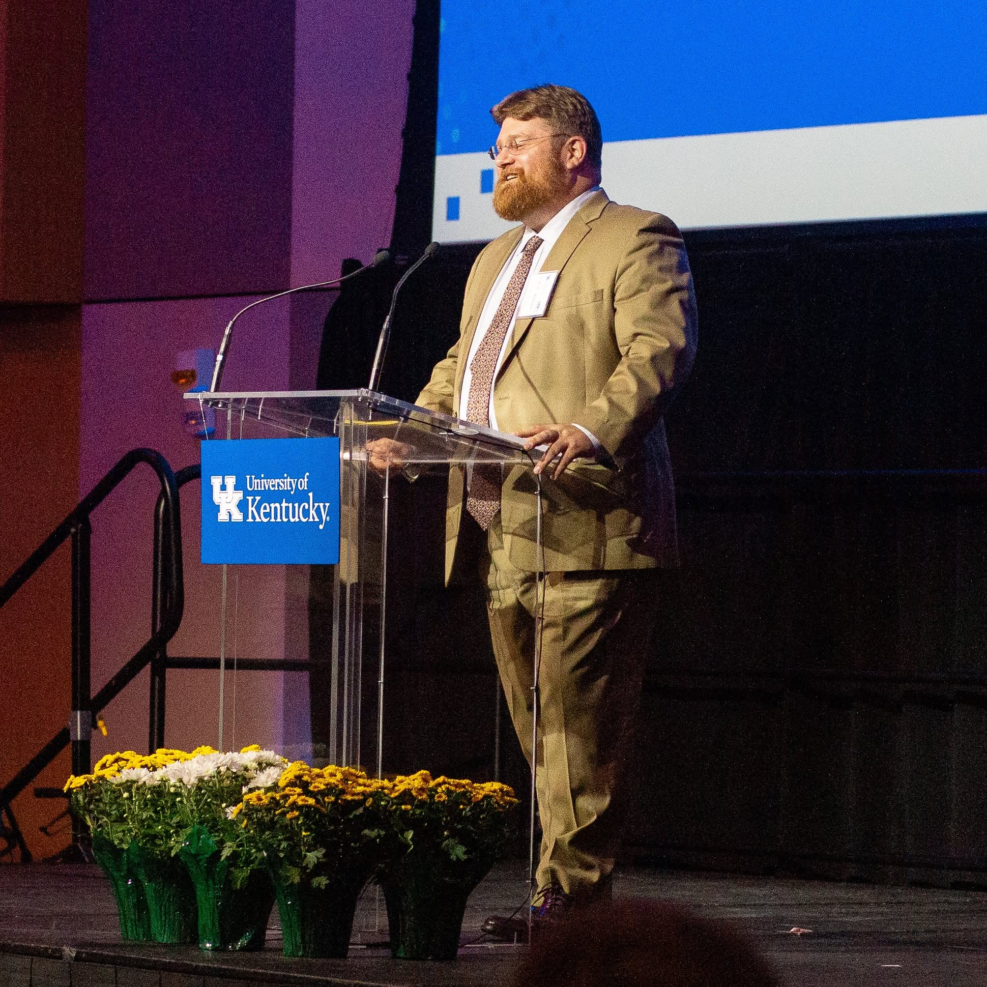 Dr. Eric Thomas Weber at a podium at the University of Kentucky. 